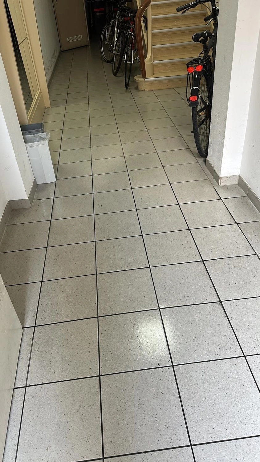 Seiffert Hausmeisterservice – Hausmeisterservice – ein mit quadratischen, hellgrau melierten Fliesen gepflasterter Flur
